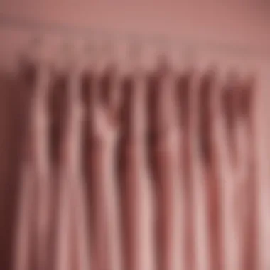 Elegant bridesmaid dresses in dusty rose draped elegantly on a hanger