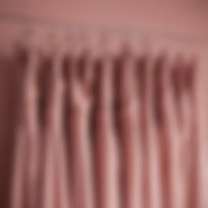 Elegant bridesmaid dresses in dusty rose draped elegantly on a hanger